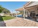 Backyard featuring a covered patio with outdoor furniture, a pool, lawn, and mature landscaping at 3528 N Crystal Ln, Avondale, AZ 85392