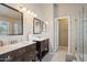 Modern bathroom featuring double sinks, granite countertops, and a separate shower at 3528 N Crystal Ln, Avondale, AZ 85392