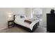 Comfortable bedroom with carpet, a side table, and an arched window at 3528 N Crystal Ln, Avondale, AZ 85392