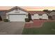 Charming single-story home with a well-maintained lawn and two-car garage at 3528 N Crystal Ln, Avondale, AZ 85392