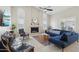 Bright living room featuring vaulted ceilings, fireplace and comfortable blue sectional at 3528 N Crystal Ln, Avondale, AZ 85392