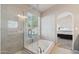Spa-like bathroom with a soaking tub and walk-in shower next to the main bedroom at 3528 N Crystal Ln, Avondale, AZ 85392