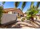 A cozy backyard featuring a hot tub and a small patio, framed by lush palm trees at 37852 W Merced St, Maricopa, AZ 85138