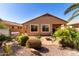 A spacious backyard with a hot tub, desert landscaping, covered patio, and fire pit at 37852 W Merced St, Maricopa, AZ 85138