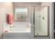 Bright bathroom with a soaking tub and walk-in shower at 37852 W Merced St, Maricopa, AZ 85138