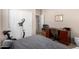 A bedroom with a desk, chair, workout equipment and closet space for a dynamic, multi-use space at 37852 W Merced St, Maricopa, AZ 85138