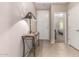 Inviting entryway with tiled floor, console table, and view into a brightly lit bedroom at 37852 W Merced St, Maricopa, AZ 85138