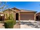 Charming single-story home with desert landscaping, tile roof, and a two-car garage, all under a clear blue sky at 37852 W Merced St, Maricopa, AZ 85138