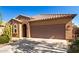 Charming single-story home with desert landscaping, tile roof, and a two-car garage, all under a clear blue sky at 37852 W Merced St, Maricopa, AZ 85138