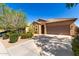 Charming single-story home with desert landscaping, tile roof, and a two-car garage, all under a clear blue sky at 37852 W Merced St, Maricopa, AZ 85138