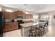 Spacious kitchen features a center island with bar seating, modern appliances, and ample cabinet space at 37852 W Merced St, Maricopa, AZ 85138