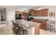Spacious kitchen features a center island with bar seating, modern appliances, and ample cabinet space at 37852 W Merced St, Maricopa, AZ 85138