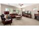 Spacious living room features comfortable leather seating and a decorative fireplace at 37852 W Merced St, Maricopa, AZ 85138