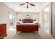 Spacious main bedroom featuring a ceiling fan, slider, and abundant natural light at 37852 W Merced St, Maricopa, AZ 85138