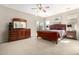 Serene primary bedroom with a ceiling fan, slider to the patio, and en-suite bath at 37852 W Merced St, Maricopa, AZ 85138