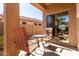 Cozy outdoor patio with seating, accessible through a sliding glass door, perfect for relaxing or entertaining at 37852 W Merced St, Maricopa, AZ 85138
