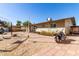 Backyard featuring a motorcycle, patio, fencing and detached structures at 411 N 111Th Pl, Mesa, AZ 85207