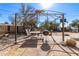 Backyard featuring a patio area with a metal pergola, outdoor furniture, and grill at 411 N 111Th Pl, Mesa, AZ 85207