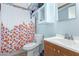Bathroom featuring a shower-tub combo and single sink vanity at 411 N 111Th Pl, Mesa, AZ 85207