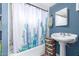 Bathroom featuring a tub and shower with a cactus shower curtain and pedestal sink at 411 N 111Th Pl, Mesa, AZ 85207