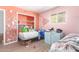 Bedroom with laminate wood flooring, closet with orange trim, and natural light at 411 N 111Th Pl, Mesa, AZ 85207