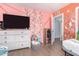 Bright bedroom with modern accents, decorative walls, and wood-look flooring at 411 N 111Th Pl, Mesa, AZ 85207