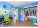 Fun bedroom featuring colorful mural, wood-look flooring, and closet at 411 N 111Th Pl, Mesa, AZ 85207