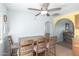 Dining area featuring a ceiling fan and natural wood furniture set at 411 N 111Th Pl, Mesa, AZ 85207