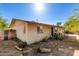 Home featuring low water landscaping, side access, and a covered porch with convenient access to the front door at 411 N 111Th Pl, Mesa, AZ 85207
