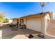 Tan home featuring a one car garage, covered front porch with seating and desert landscaping at 411 N 111Th Pl, Mesa, AZ 85207
