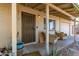Cozy front porch featuring seating and front door access to a charming home, with desert landscaping at 411 N 111Th Pl, Mesa, AZ 85207