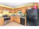 Traditional-style kitchen with wooden cabinetry, granite countertops, and tile flooring at 411 N 111Th Pl, Mesa, AZ 85207