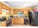 Traditional-style kitchen with wooden cabinetry, granite countertops, and tile flooring at 411 N 111Th Pl, Mesa, AZ 85207