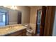 Tiled bathroom featuring a toilet, vanity, and doorway to another room in the house at 4242 W Sandra Ter, Phoenix, AZ 85053