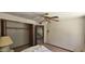 This bedroom features a ceiling fan and an open closet with a carpeted floor at 4242 W Sandra Ter, Phoenix, AZ 85053