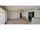 Spacious bedroom featuring a ceiling fan, carpet flooring, and an open door leading to the bathroom at 4242 W Sandra Ter, Phoenix, AZ 85053