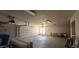 A spacious garage featuring an automatic garage door, storage cabinets, and bright lighting at 4242 W Sandra Ter, Phoenix, AZ 85053