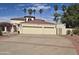 Spacious three-car garage with an extended driveway, complemented by the home's clay tile roof at 4242 W Sandra Ter, Phoenix, AZ 85053