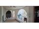 Upstairs hallway with arches overlooking a Gathering room with a chandelier at 4242 W Sandra Ter, Phoenix, AZ 85053