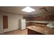 The kitchen features an island counter, wood cabinets, tile flooring and a ceiling fan at 4242 W Sandra Ter, Phoenix, AZ 85053