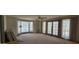 Bright living room with large windows, neutral carpet, ceiling fan, and beautiful natural light at 4242 W Sandra Ter, Phoenix, AZ 85053