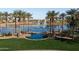 This aerial showcases the community's resort-style pool, lake with fountains and lush landscaping at 42430 W Oakland Dr, Maricopa, AZ 85138