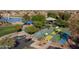 This scenic aerial view highlights a basketball court, walking paths and a lushly landscaped park for recreation at 42430 W Oakland Dr, Maricopa, AZ 85138