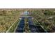 Scenic aerial view of the community featuring a beautiful lake, lush landscaping, and well-maintained roadways at 42430 W Oakland Dr, Maricopa, AZ 85138