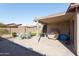 Charming back patio with covered area, table, chairs, grill and well kept landscaping, perfect for entertaining at 42430 W Oakland Dr, Maricopa, AZ 85138