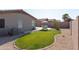 A backyard offers a well-maintained lawn, patio, and privacy fencing for outdoor enjoyment at 42430 W Oakland Dr, Maricopa, AZ 85138