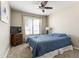 Bedroom with a ceiling fan, large window providing natural light, and comfortable furnishings at 42430 W Oakland Dr, Maricopa, AZ 85138
