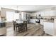 Eat-in kitchen and dining area featuring stainless steel appliances and wood-look flooring at 42430 W Oakland Dr, Maricopa, AZ 85138