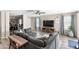 Comfortable living room with stylish decor, a ceiling fan, and a glimpse into the home office space at 42430 W Oakland Dr, Maricopa, AZ 85138