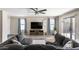 Spacious living room with a modern ceiling fan, decorative accents, and cozy sectional sofa at 42430 W Oakland Dr, Maricopa, AZ 85138